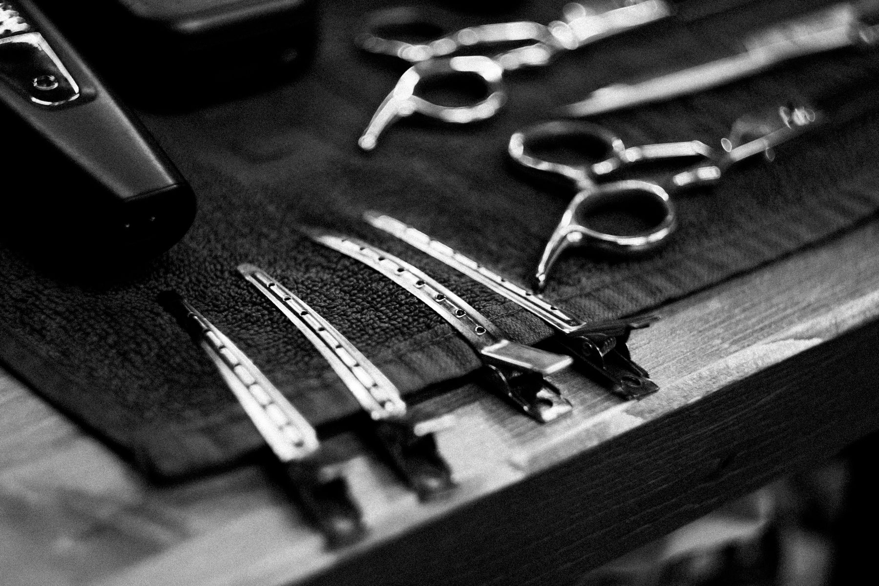 Traditional barber scissors and combs on a towel, illustrative stock